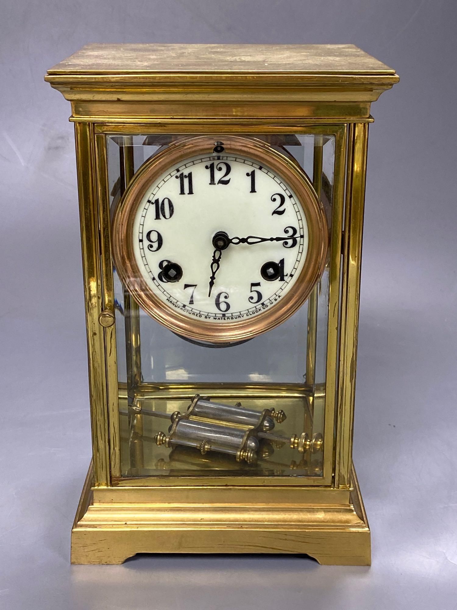 A lacquered brass four-glass mantel clock, Waterbury Clock Co., USA, gong striking movement, height 24cm